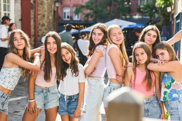 Happy teenagers or childs having fun together on city background