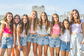 Happy teenagers or childs having fun together on city background