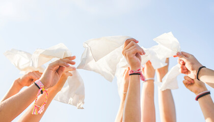 lot of hands holding tissue with sky on the background. A flu virus concept