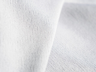 A close-up of white fabric with a texture that creates a soft and elegant background, ideal for...