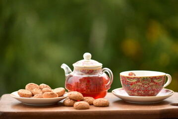 teapot, cup of tea and cookies