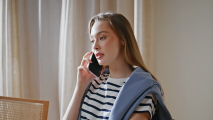 Casual lady speaking smartphone in sunlit home closeup. Manager consulting 