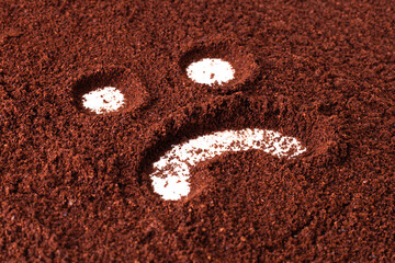 sad face in coffe powder.