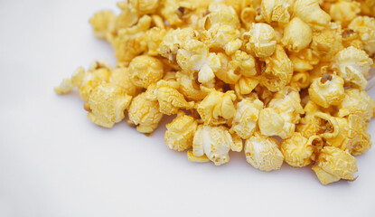 Pile of homemade popcorn, made from seeds of maize or corn by baking or heating, mixed with salt, sugar and butter caramel. Concept, delicious snack. Agriculture product as food.