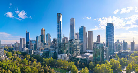 Obraz premium Aerial View of City Skyline and Skyscrapers Under Blue Sky and White Clouds