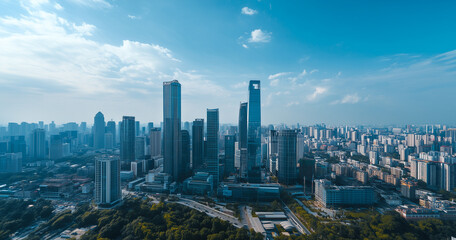 Obraz premium Aerial View of City Skyline and Skyscrapers Under Blue Sky and White Clouds