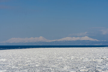 Drift ice and Shiretoko mountain in Hokkaido Japan  © 善弘 石垣