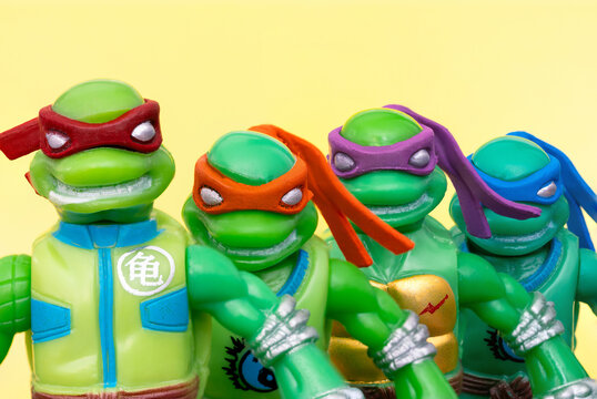 Teenage Mutant Ninja Turtles on a yellow background. Raphael, Michelangelo, Donatello and Leonardo