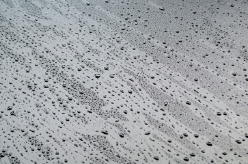 Surface view of water droplets on dark cover background. Water or rain droplets and wallpaper design concept