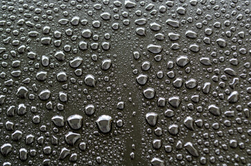 Close up view of rain droplets on dark cover background. Rain droplets and wallpaper design concept