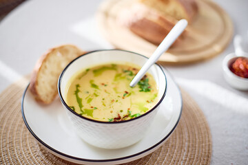 Bowl of potato soup with parsley and bacon with toasted bread croutons in white bowl. Comfort meal