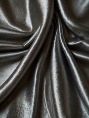 Shimmering silver silk fabric draped elegantly, highlighting its textures.