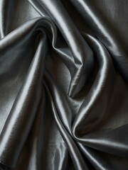 Shimmering silver silk fabric draped elegantly, highlighting its textures.