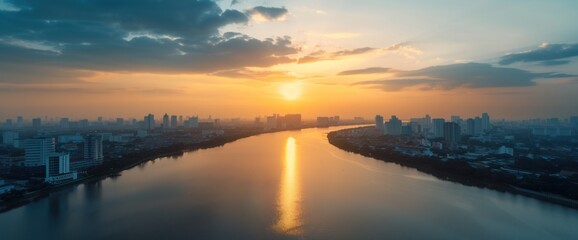 Fototapeta premium Breathtaking Sunset Over Urban Skyline Reflected in Serene River Waters