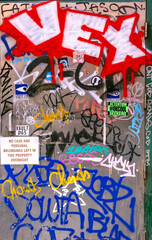 Colorful graffiti scrawled on a metal door creating a background with an interesting texture suitable for an urban concept