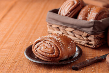 Korvapuusti, traditional finnish cinnamon and cardamom rolls, fresh baked buns on the plate, sweet dessert Sweden and Finland