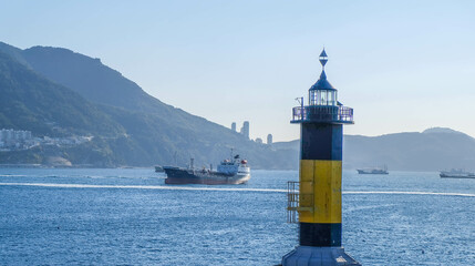 Yellow and black painted lighthouse, floating in the sea in Busan, South Korea.