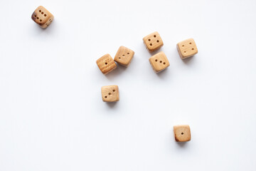 These are photos of wooden dice on a white background. They include shots of aligned, scattered, and stacked dice There are photos of a single die, a pyramid of dice.