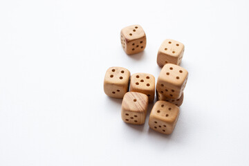 These are photos of wooden dice on a white background. They include shots of aligned, scattered, and stacked dice There are photos of a single die, a pyramid of dice.