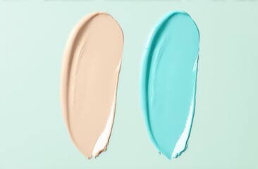 Fototapeta premium Oil or cream or scrub macro texture smears. Skincare Texture Swatch. Natural gel smears or drops placed on pastel green background. Face Cream. Cleanser Serum Treatment. Pastel colors.