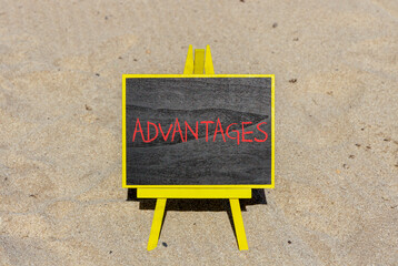 Advantages symbol. Concept word Advantages on beautiful chalk blackboard. Beautiful sand beach...