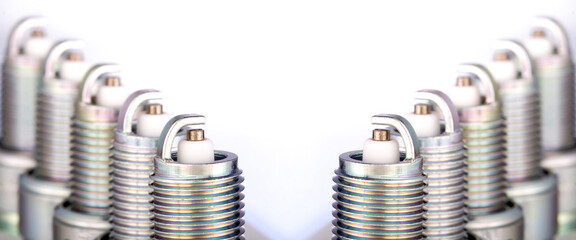 New car spark plugs on gray background