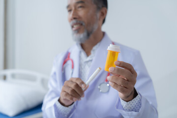 Medical professional is holding a prescription bottle and an inhaler while discussing treatment...