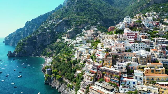 Colorful houses on cliffs, blue sea and beaches. This is Positano, an Italian town.