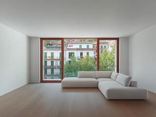 Fototapeta premium Modern living room with large windows and view of green trees and buildings in bright daylight