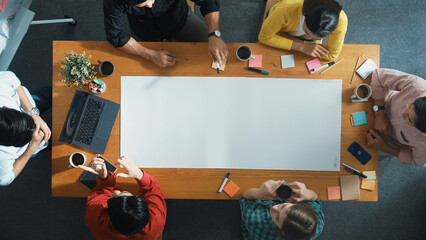 Top view of diverse group walking at boardroom and brainstorming idea. Smart startup team sharing...