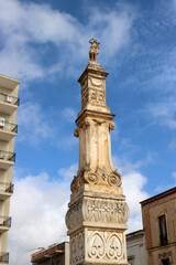 The majestic Column of St. John the Baptist, which dominates the suggestive Piazza San Giovanni in the heart of Sava, Puglia, Italy
