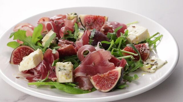 salad with figs blue cheese jamon on white plate food
