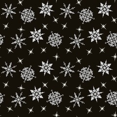 Seamless pattern for winter design with snowflakes on a black background