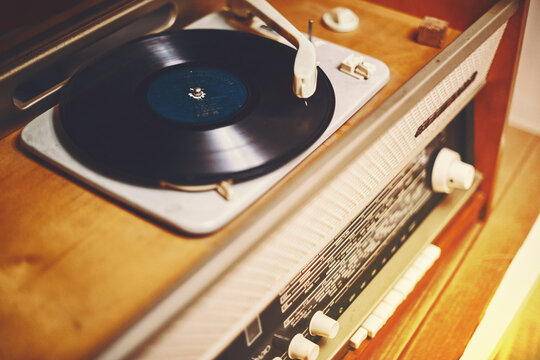 Istra, Russia - September 06, 2021: Vinyl record, spinning on a turntable, Vintage record player with radio 60's.