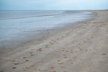 the lonely beach of rockanje, the netherlands, in the fall in bad weather