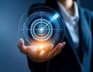 A businessman's hand holds a futuristic interface with a target and arrow, representing the power of focus and vision in business.