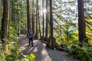 Obraz premium Father and Child Enjoying a Peaceful Hike in Rolley Lake, Mission, BC