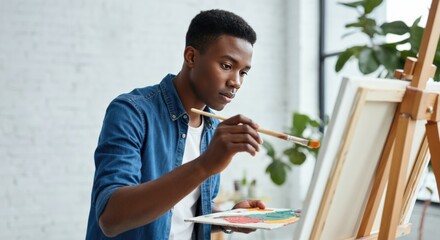 Concentrated Man Painting on Canvas
