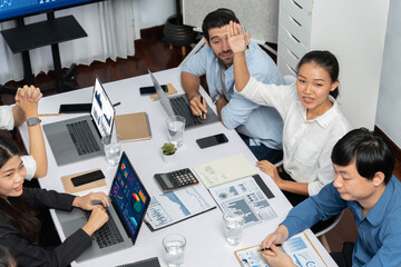 Office worker raise hand up asking for question during business meeting on data analysis using BI...