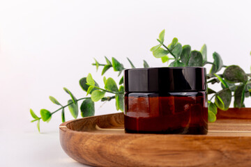 Natural cosmetic cream jar mockup on green leaf background. Makeup product blank container. Body care organic lotion, cleaning scrub. Facial mask, moisturising balm for hair closeup image.