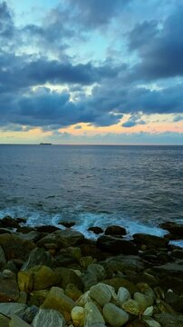 Slow motion of waves breaking on the rocks on a tropical beach at sunset. Macuto Coast, Venezuela.