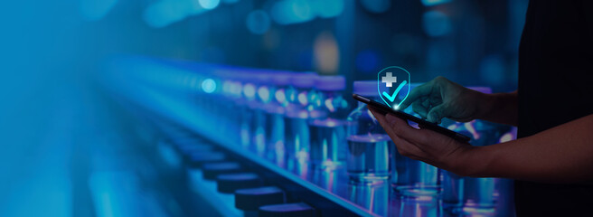 person operates a tablet while inspecting medical vials on a production line. A digital checkmark icon signifies approval and quality assurance, with a glowing blue background