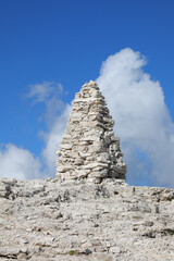 very big pile of stones known as a cairn in the mountains symbolizing either a prayer or a wayfinding marker in the European Alps