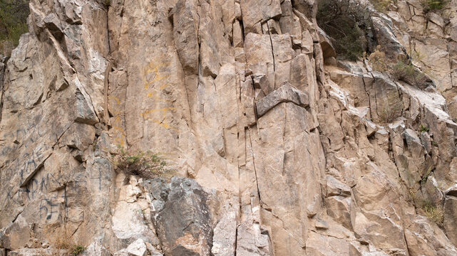 Close-up of weathered rock face showing intricate patterns and textures, geological formation, natural abstract background, climbing concept