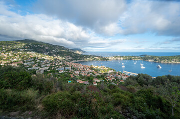 Yachts at anchor in natural harbor of Villefranche-sur-Mer on sunny summer afternoon.