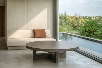 Fototapeta premium Modern living area with a minimalist sofa and a scenic outdoor view in soft natural light