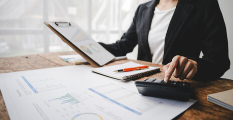Portrait of a woman working on a tablet computer in a modern office. Make an account analysis report. real estate investment information financial and tax system concepts..