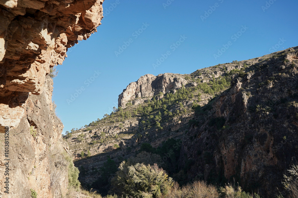 Wall mural beautiful rocky gorge. overhanging rock mountains. mountain landscape. cliff, limestone rock covered