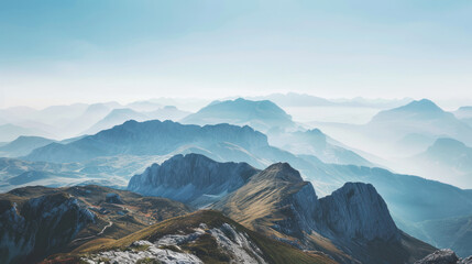 Fototapeta premium A panoramic view of a vast mountain range, with rolling hills and distant peaks under a clear sky