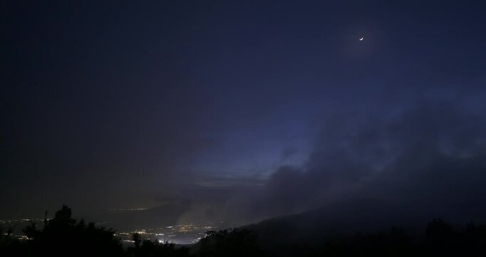View of Gotemba city and the crescent moon from the foggy Hakone mountains in Japan. C4K,H.264,422,10bit
